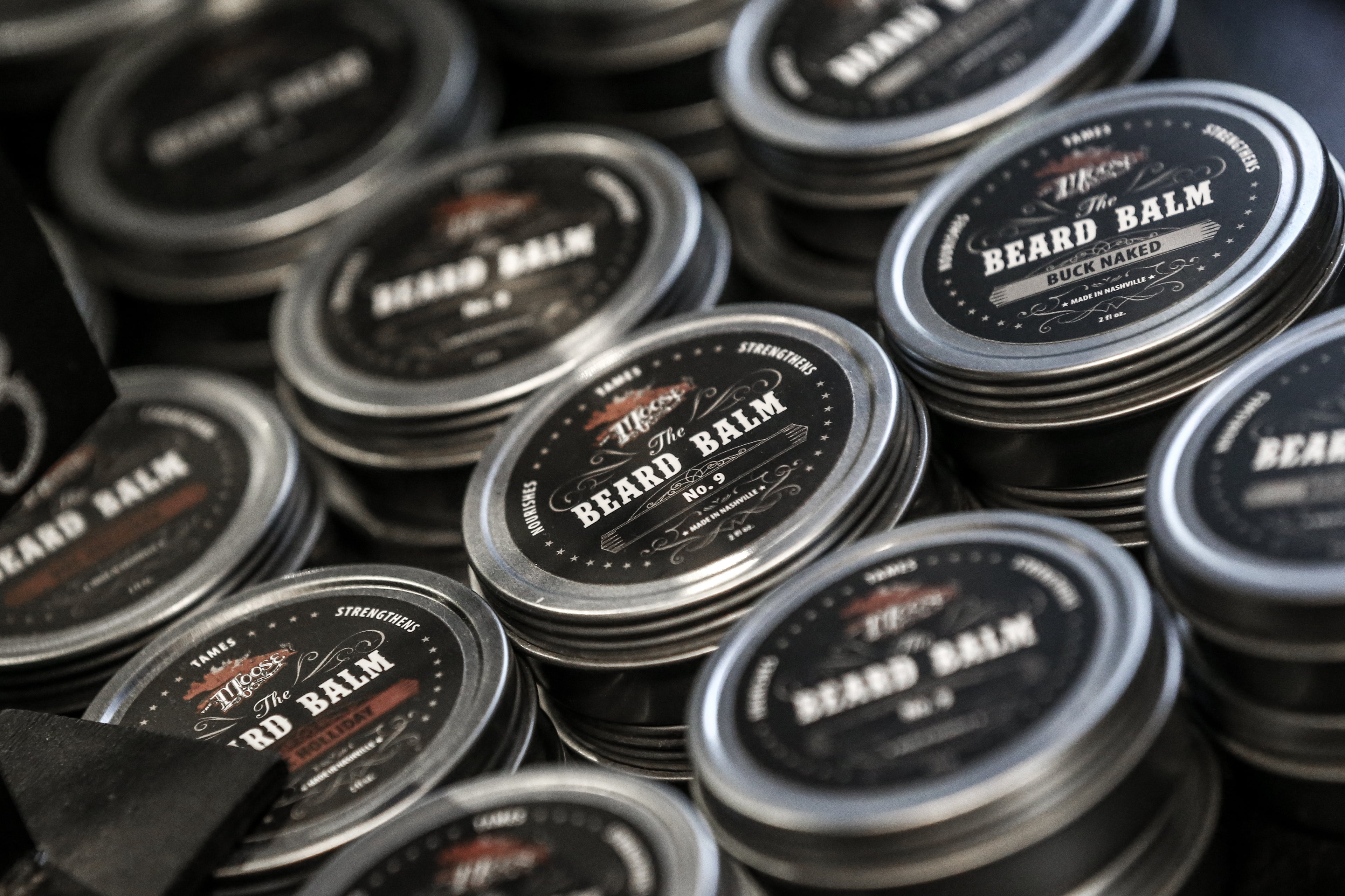 Stacked cans of The Moose Beard Palm Men's Grooming Product